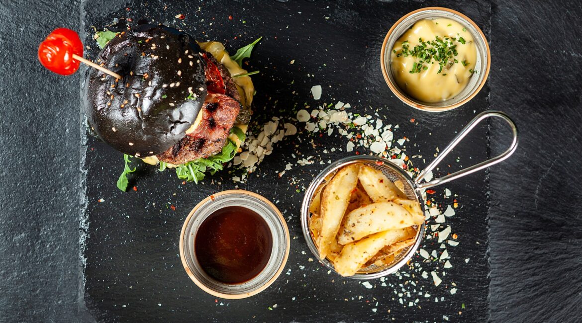 burger-and-friench-fries-on-black-stone-table-chee-E7PRL84-min